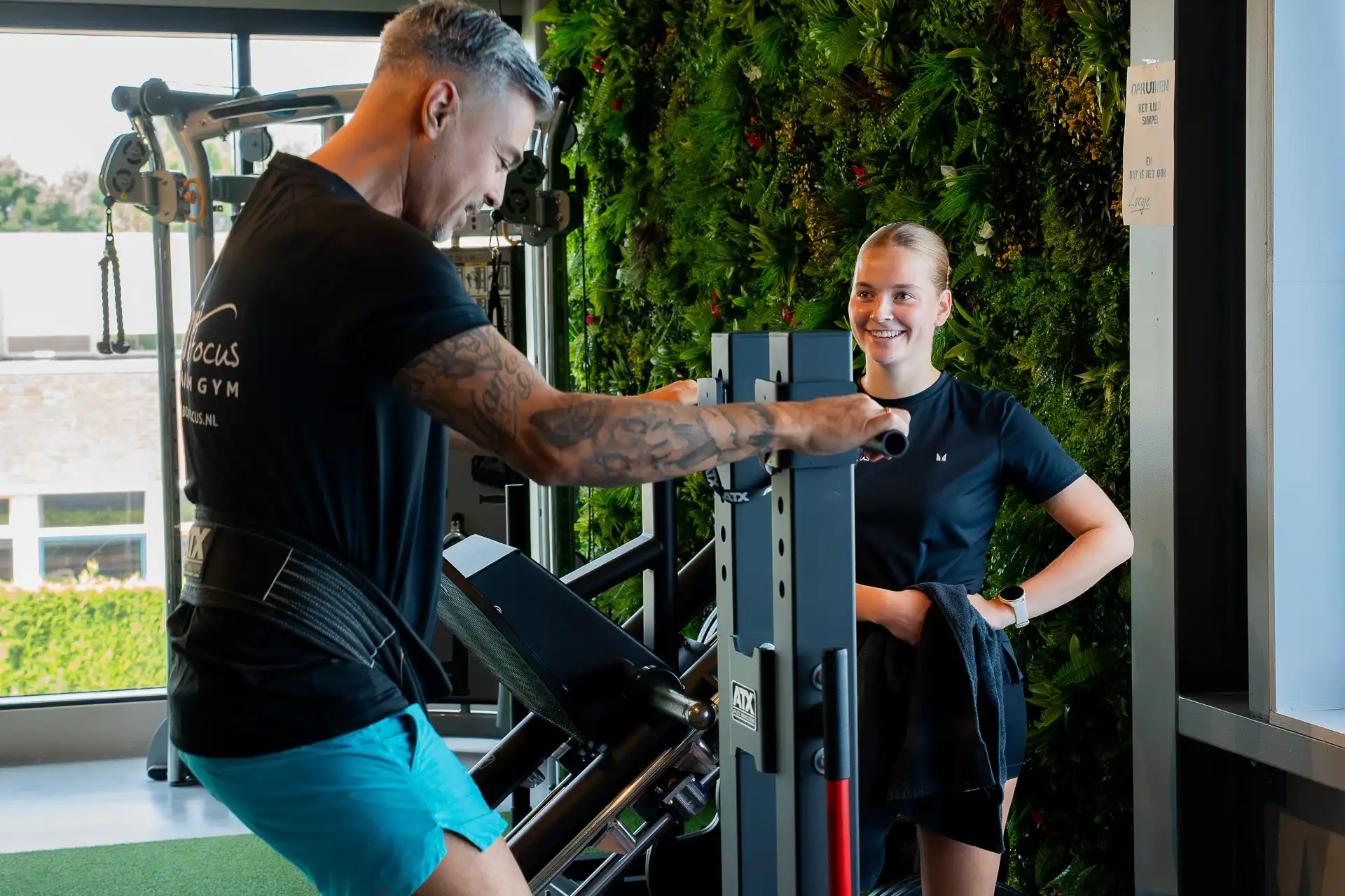 Coach begeleidt sportmaatje tijdens beenoefening